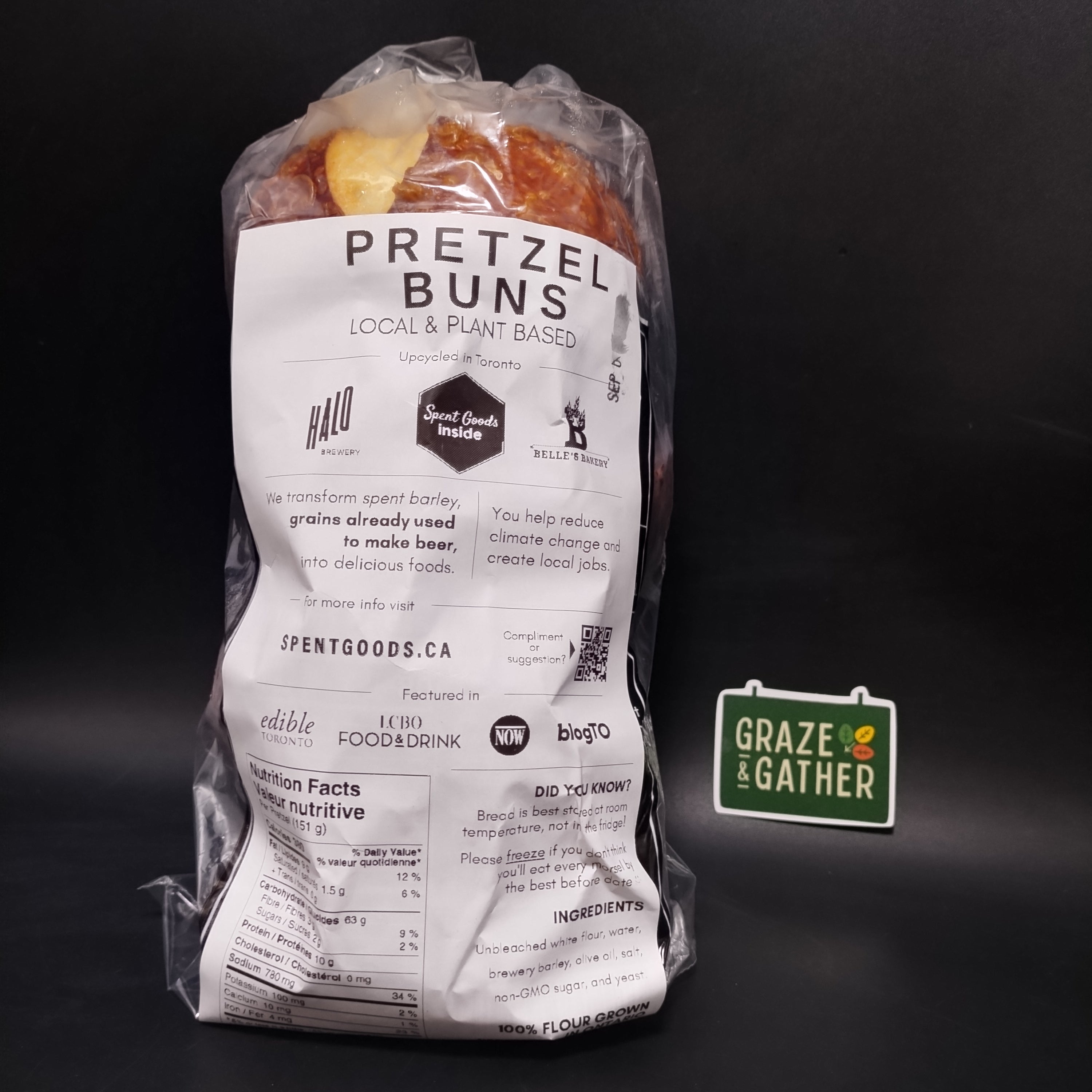 Packaged pretzel buns with a visible brand logo on a dark background