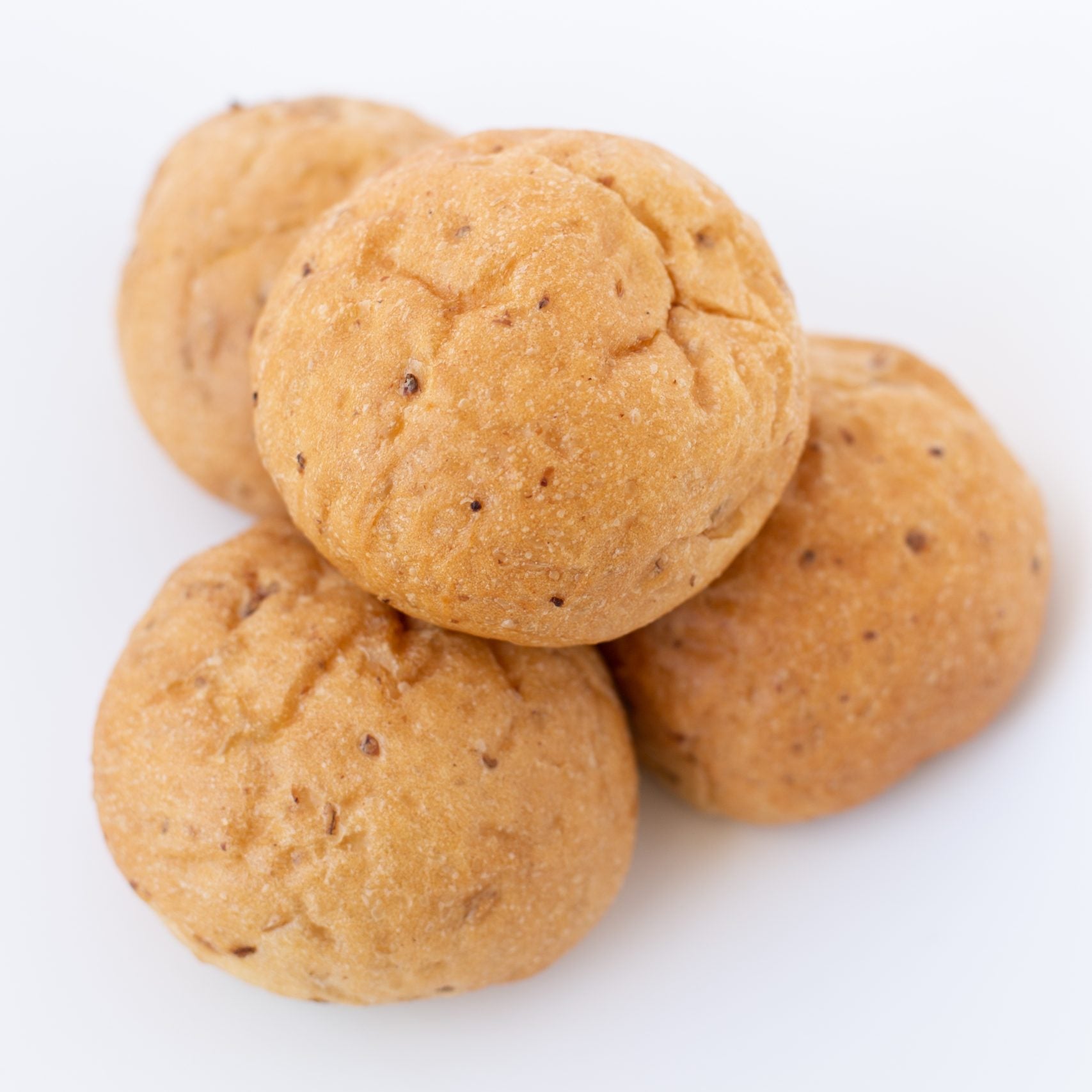 Three round, brown cookies on a white background