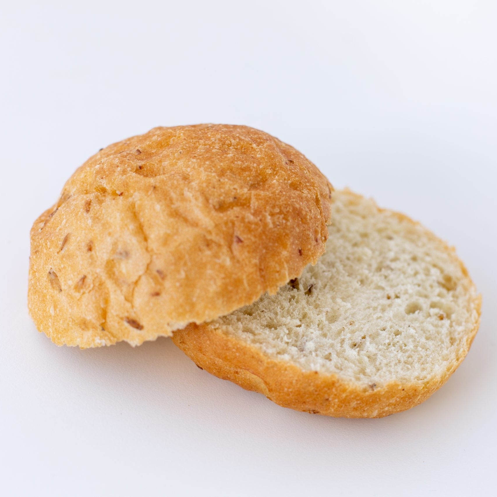 Half-cut bread roll on a white background