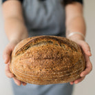 Loaf of Multigrain Sourdough being held