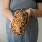 person holding loaf of bread