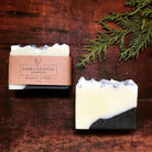 Two bars of bergamot and cedar soap.