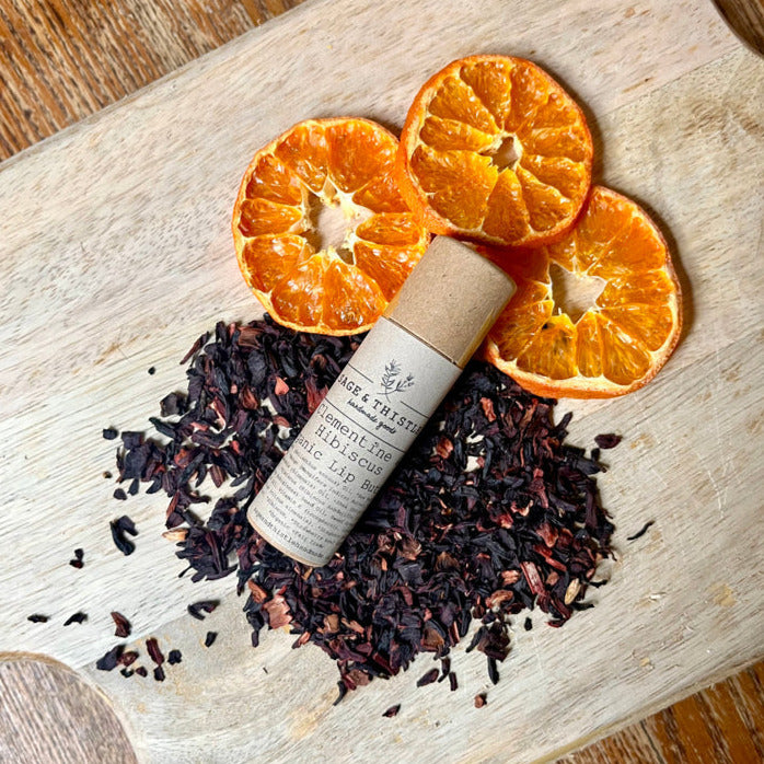 lip butter stick in dried clementine and hibiscus petals