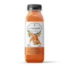 A bottle of carrot orange cold pressed juice.