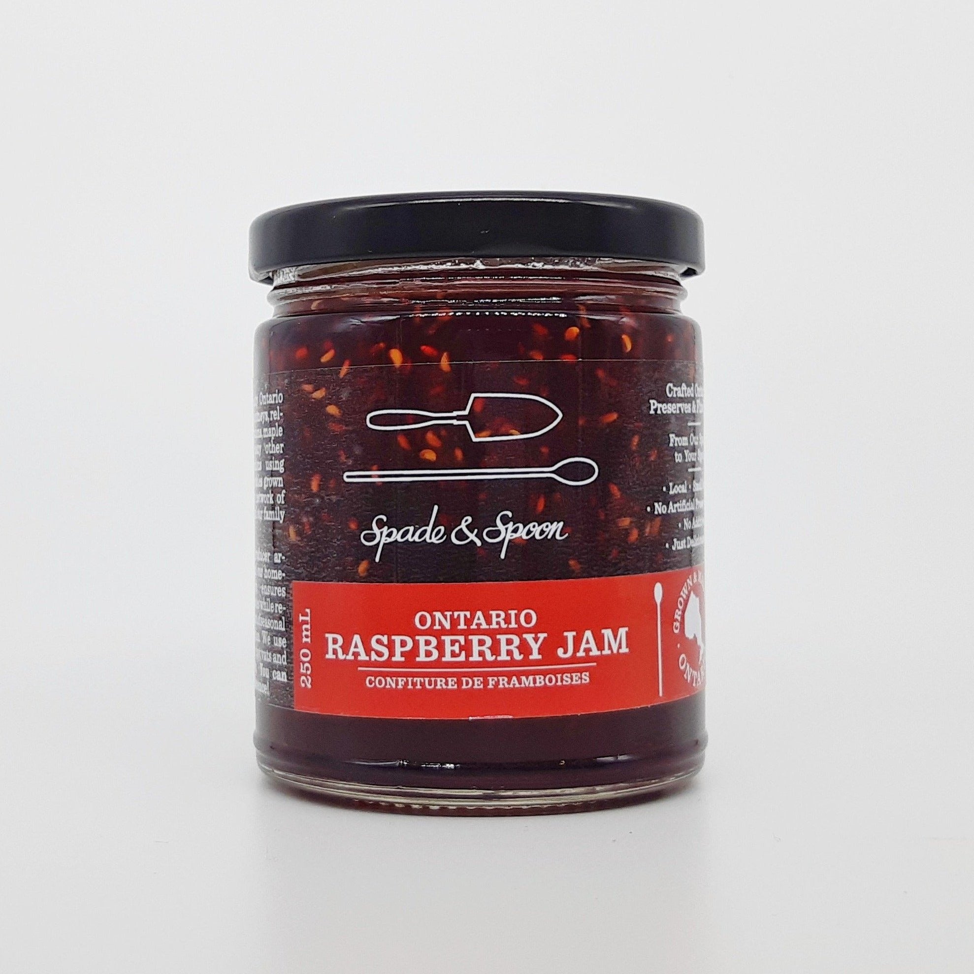 Jar of raspberry jam on a white background